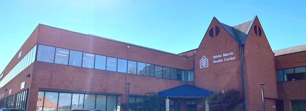 An image of the White Marsh Town center from the outside on a blue sky day