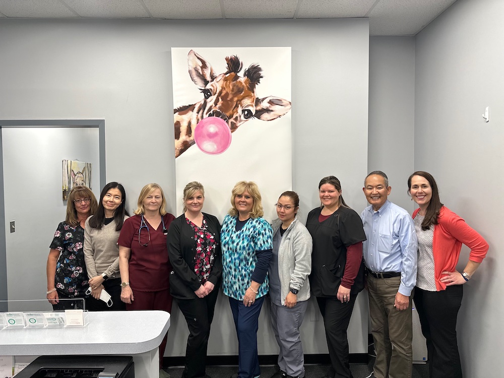 Image of the Honeygo Pediatric staff including nurses, office receptionists, Dr. Wieslawa D. Wisinski, Dr. Lee, Dr. Christina Halley, Dr. Murakoshi.